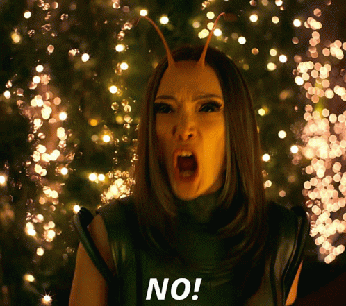 A Woman With Antennas On Her Head Says No In Front Of Christmas Lights GIF