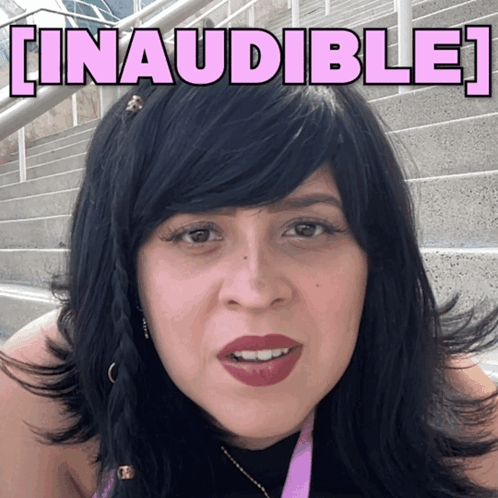 A Woman With Black Hair Is Standing In Front Of A Sign That Says Linausible GIF