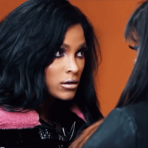A Woman With Black Hair Looks At Another Woman GIF