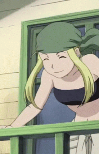 A Woman With Blonde Hair And A Green Headband Is Smiling GIF