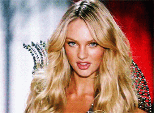 A Woman With Blonde Hair And Blue Eyes Is Wearing A Crown GIF