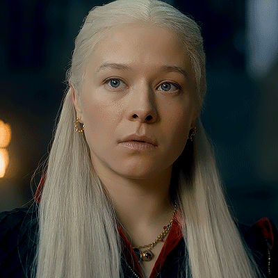 A Woman With Blonde Hair And Blue Eyes Is Wearing A Necklace And Earrings GIF
