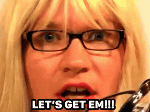 A Woman With Blonde Hair And Glasses Says Let 'S Get Em GIF