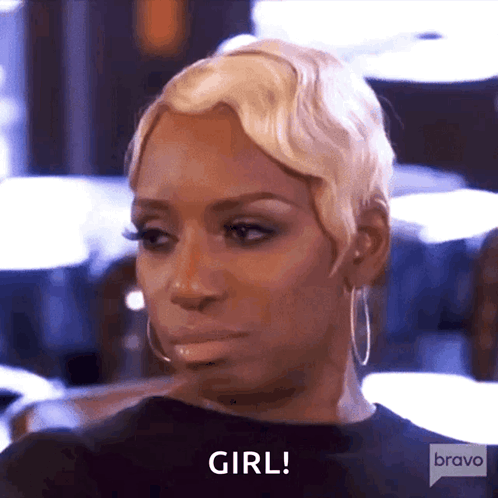 a woman with blonde hair and hoop earrings is saying girl