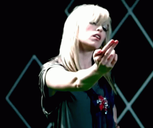 A Woman With Blonde Hair And Red Nails Is Making A Middle Finger Gesture GIF