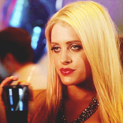 A Woman With Blonde Hair Is Holding A Cup With A Straw In Her Hand GIF