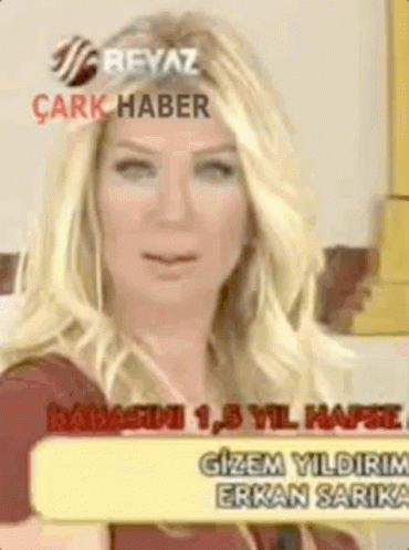 A Woman With Blonde Hair Is Holding A Sign That Says Gizem Yildirim GIF