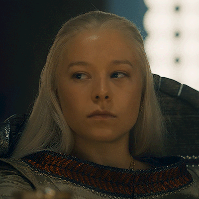 A Woman With Blonde Hair Is Looking At The Camera GIF