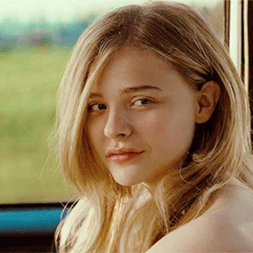 A Woman With Blonde Hair Is Looking At The Camera GIF