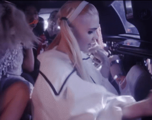 A Woman With Blonde Hair Is Sitting In A Car GIF