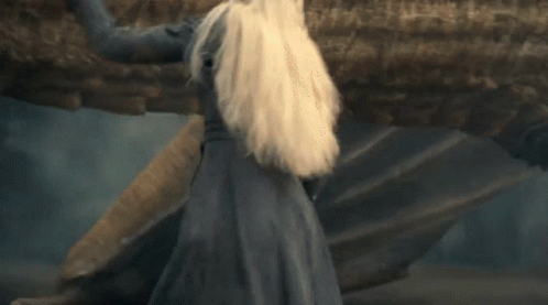 A Woman With Blonde Hair Is Smiling And Looking Up GIF