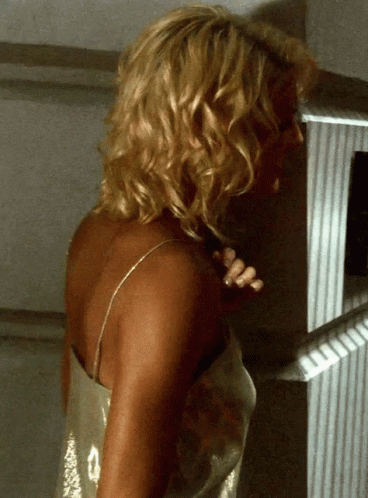Blonde Woman Standing In Front Of White Wall GIF