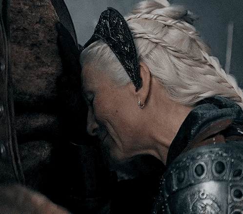 A Woman With Blonde Hair Is Wearing A Black Headband GIF