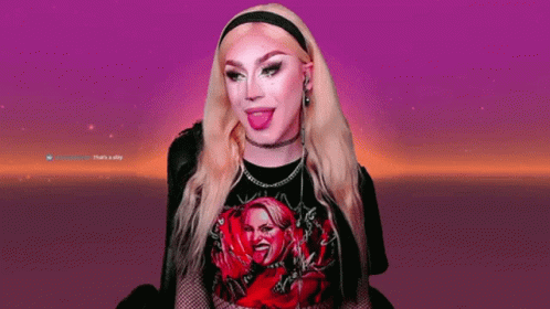 A Woman With Blonde Hair Is Wearing A Black Shirt With A Picture Of A Woman On It GIF