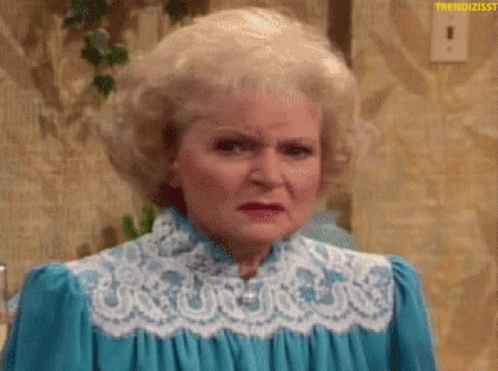 A Woman With Blonde Hair Is Wearing A Blue Dress With White Lace . GIF