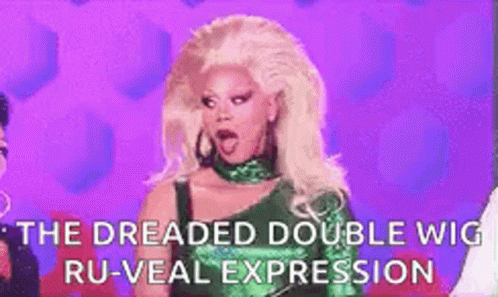 A Woman With Blonde Hair Is Wearing A Green Dress And A Green Wig . GIF