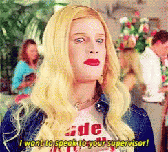 A Woman With Blonde Hair Is Wearing A T-Shirt That Says " I Want To Speak To Your Supervisor " GIF
