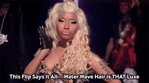 A Woman With Blonde Hair Says This Flip Says It All-Water Wave Hair Is That Luxe GIF