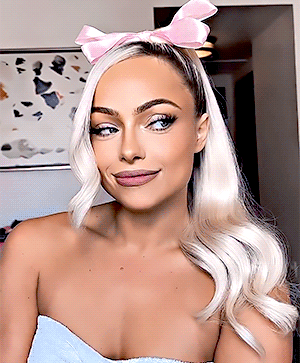 A Woman With Blonde Hair Wearing A Pink Headband GIF