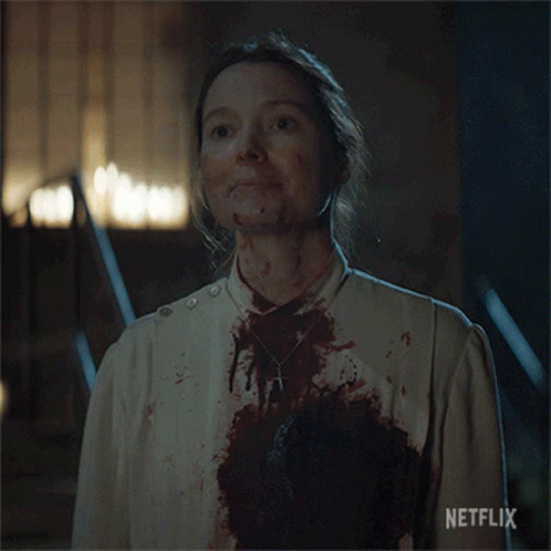 A Woman With Blood On Her Face And A Netflix Logo On The Bottom Right GIF