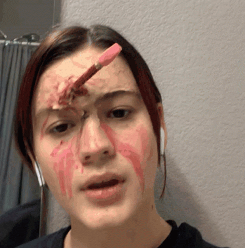 A Woman With Blood On Her Face Has A Pencil In Her Eye GIF