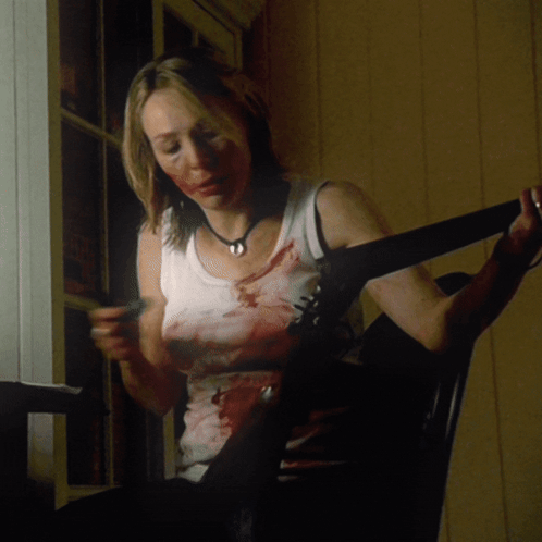 Woman With Blood On Face Sitting Holding Belt GIF
