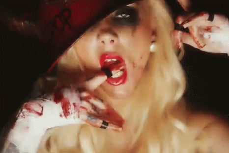 A Woman With Blood On Her Face Is Wearing A Hat And Lipstick GIF