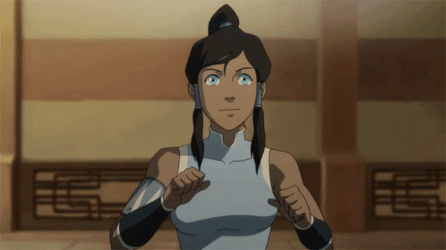 A Woman With Blue Eyes And A Ponytail Is Standing In Front Of A Wall GIF