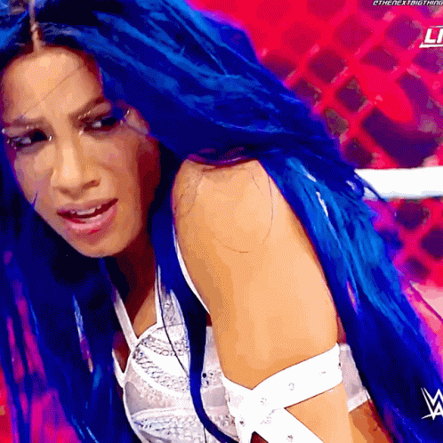a woman with blue hair and a w logo on her shoulder