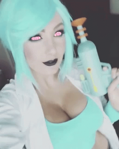 A Woman With Blue Hair And Pink Eyes Is Holding A Gun GIF