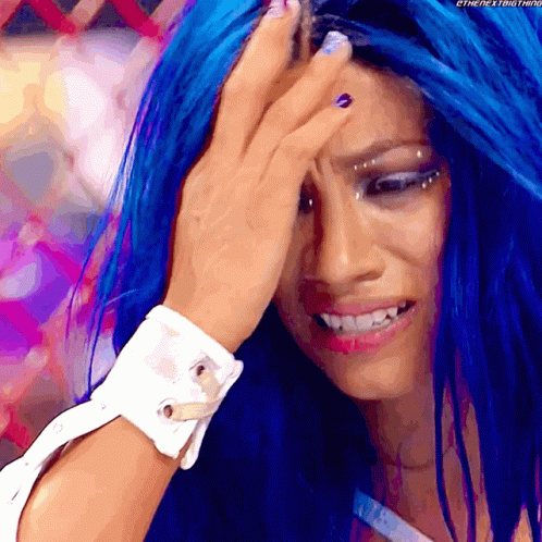 a woman with blue hair is covering her forehead with her hand