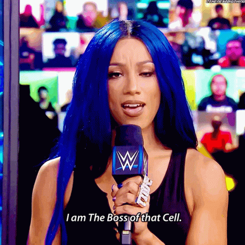 a woman with blue hair is holding a microphone that says i am the boss of that cell