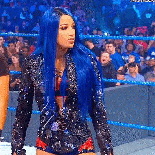 A Woman With Blue Hair Is In A Wrestling Ring GIF