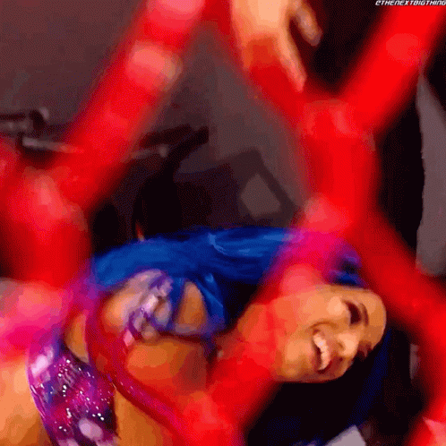 a woman with blue hair is laying on her back with her arms outstretched