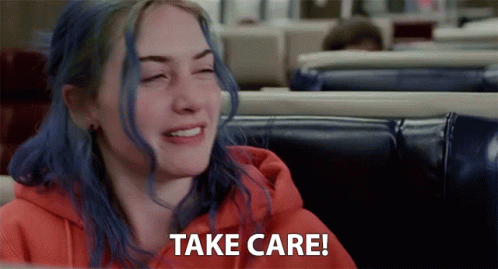 A Woman With Blue Hair Is Sitting In A Diner And Saying Take Care GIF