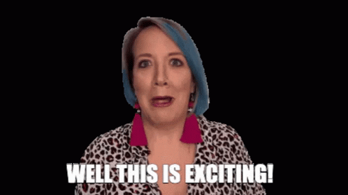 A Woman With Blue Hair Is Smiling And Saying Well This Is Exciting ! GIF