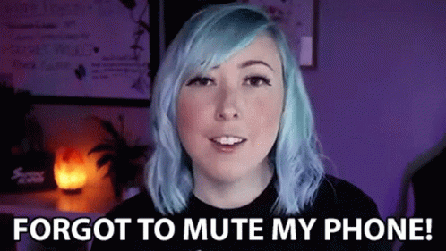 A Woman With Blue Hair Is Standing In Front Of A Purple Wall . GIF