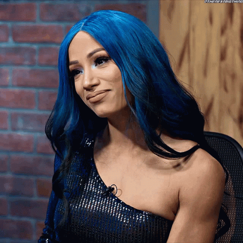 A Woman With Blue Hair Is Wearing A Black Top GIF