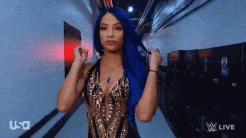 A Woman With Blue Hair Is Wearing A Gold And Black Dress GIF