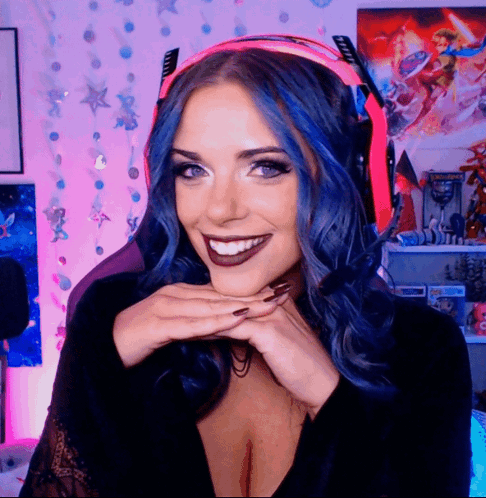 A Woman With Blue Hair Is Wearing A Headset GIF