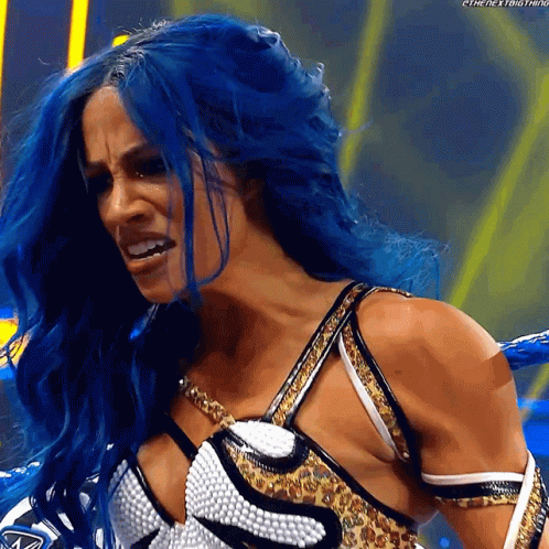 A Woman With Blue Hair Is Wearing A Leopard Print Top GIF