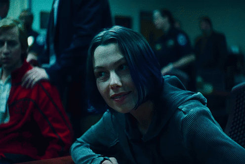 A Woman With Blue Hair Sits At A Table With A Man In A Red Jacket GIF
