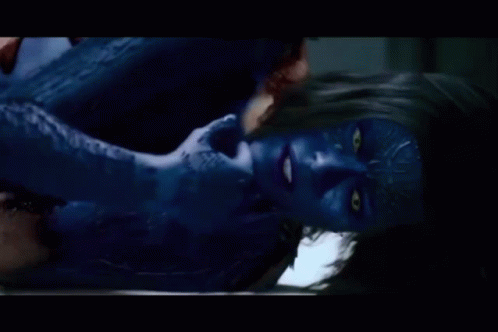 A Woman With Blue Paint On Her Face Is Laying Down GIF