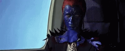 A Woman With Blue Paint On Her Face Is Sitting In A Car . GIF