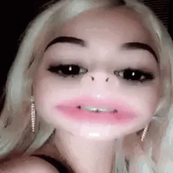A Woman With Braces On Her Teeth Is Making A Funny Face With Her Mouth Wide Open . GIF