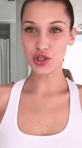 A Woman With Braces On Her Teeth Is Taking A Selfie GIF