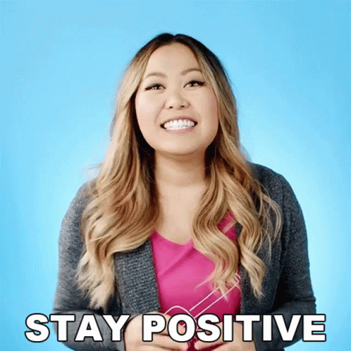 A Woman With Braces On Her Teeth Smiles And Says Stay Positive GIF