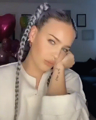 A Woman With Braids Has A Tattoo On Her Wrist That Says " I 'M Okay " GIF