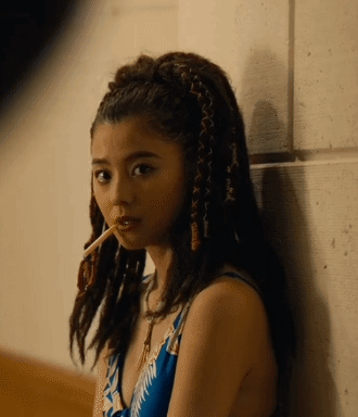 A Woman With Braids In Her Hair Smoking A Cigarette GIF