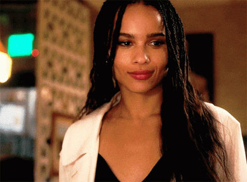 A Woman With Braids Is Smiling And Wearing A White Shirt GIF